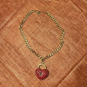 Gold chain and red heart necklace